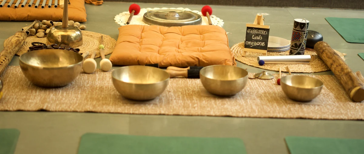 Singing bowls and a cushion laid out before a session at The Sphere