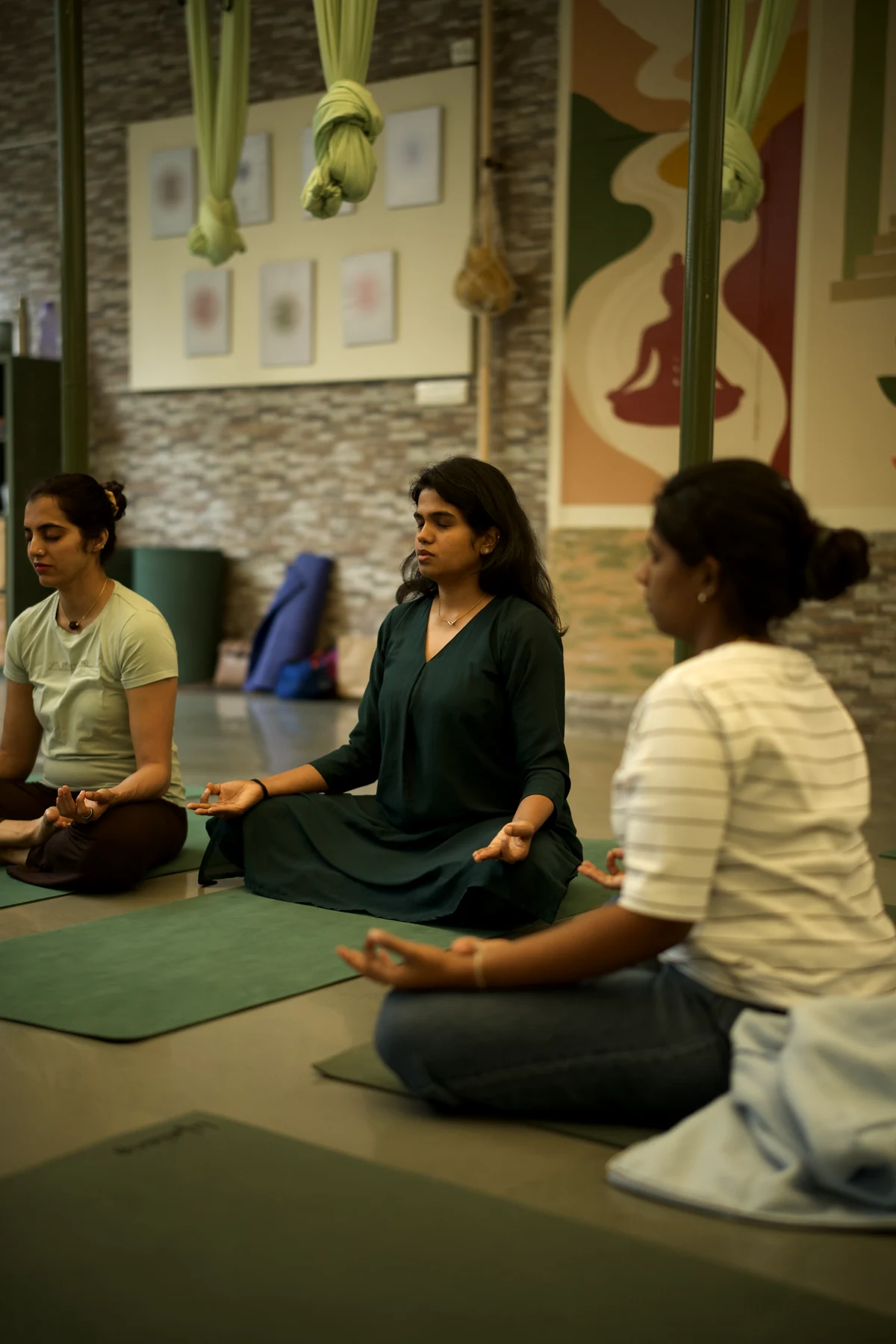 Women seated together in a quiet meditation circle at The Sphere