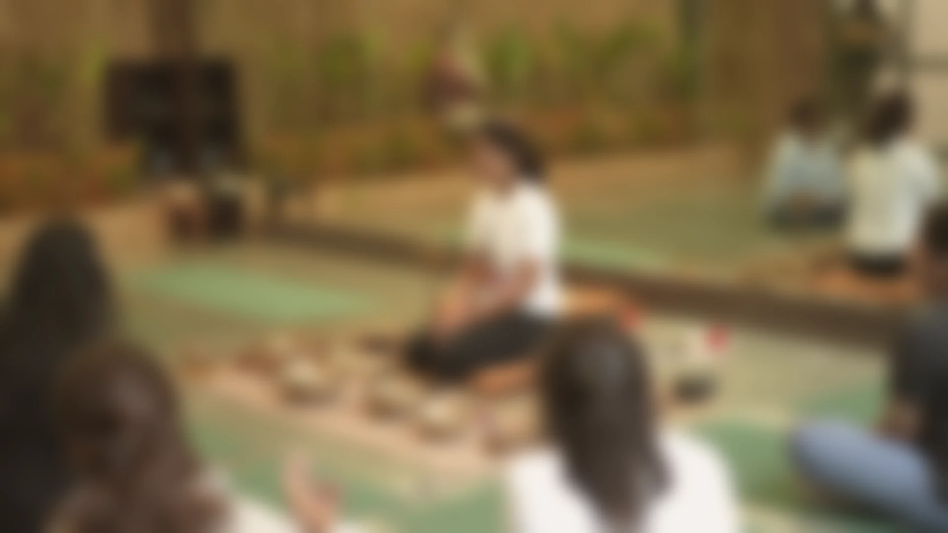 A circle of women gathered at The Sphere, in soft focus