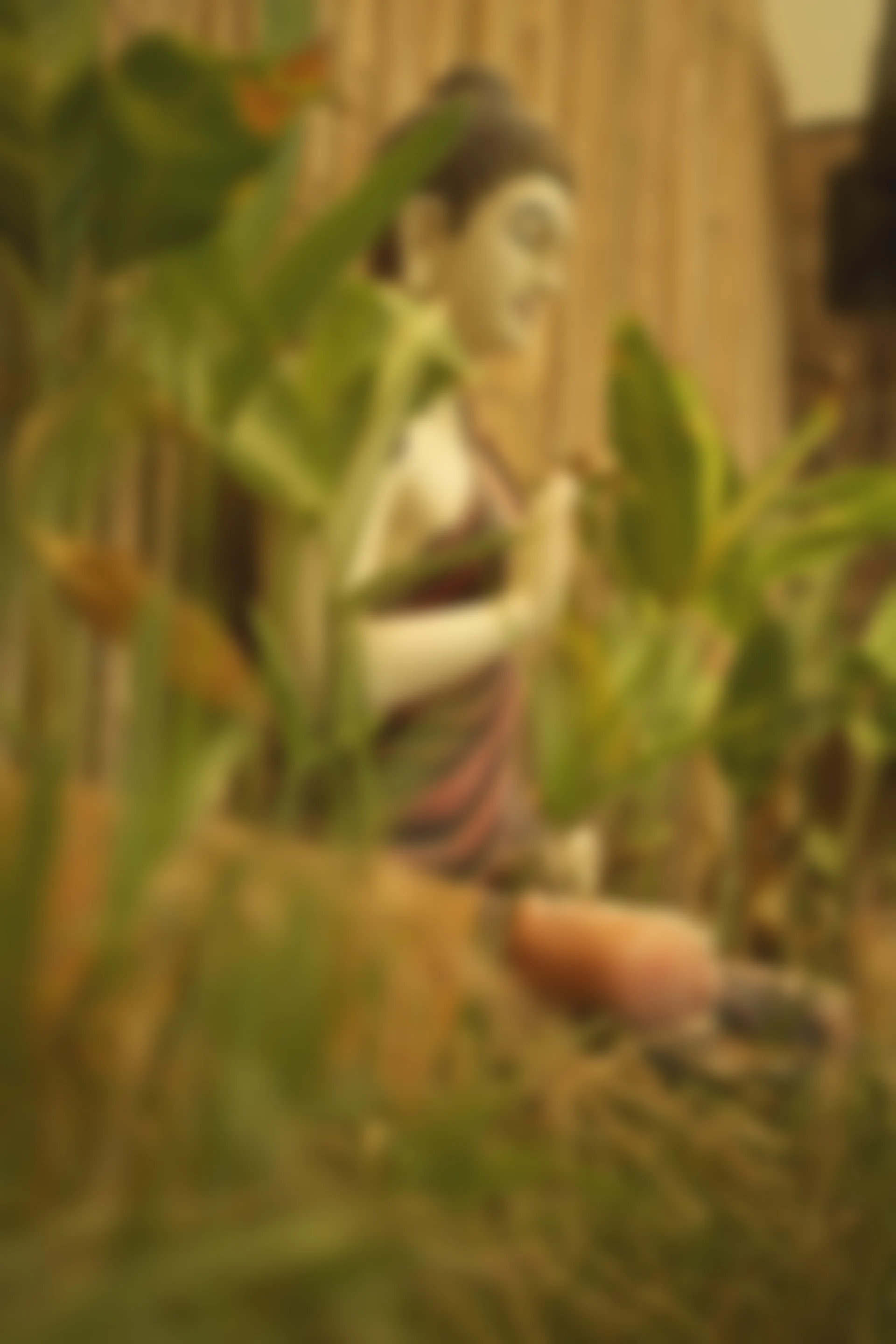 Leaves and a Buddha figure in soft focus at The Sphere